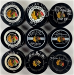 Chicago Blackhawks Signed Official NHL Game Puck Group of 16 Incl. Bobby Hull, Tony Esposito, Denis Savard and Others (BAS)